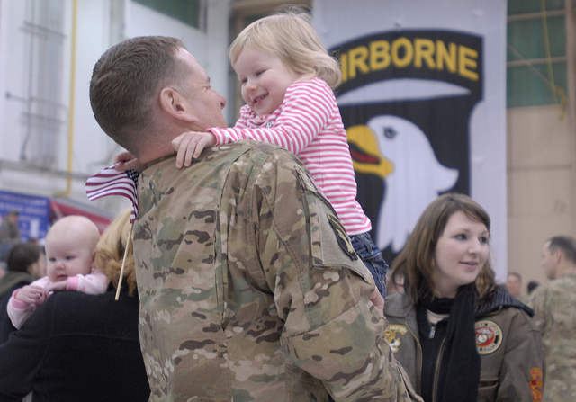 A soldier embraces his daughter. Photo credit: US Army, Not Affiliated with Protect My Public Media, Veterans Coming Home