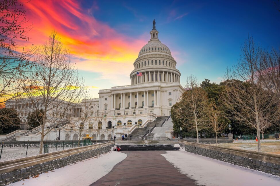 The US Capitol dome at sunset in the winter.
